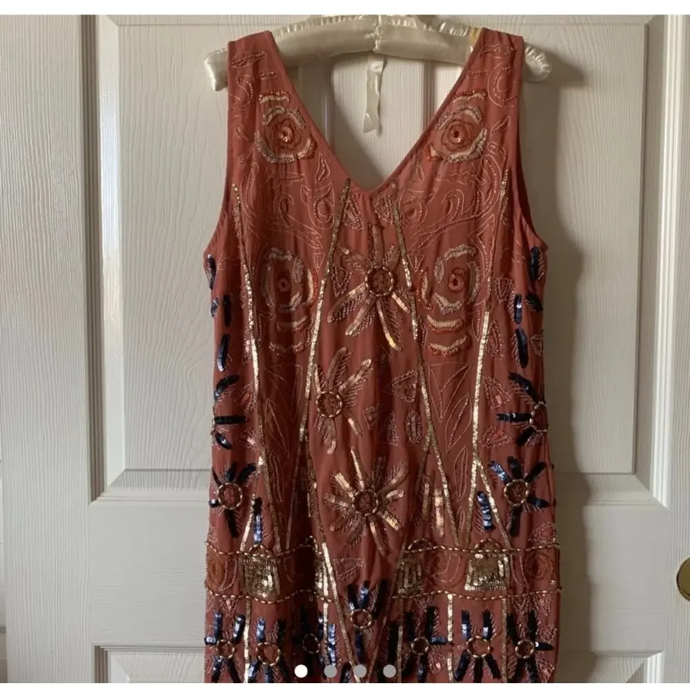 Free People coral tunic dress features intricate gold and blue sequin Size small